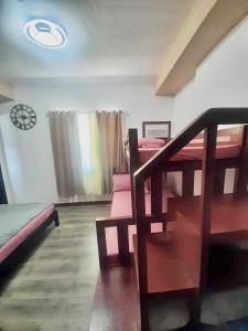 a room with bunk beds and a staircase in it at Spacious Combine Family Unit Condo at Mesaverte Residences downtown near SM Gaisano Robinson and Centrio in Cagayan de Oro