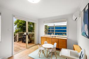 a kitchen and dining room with a table and chairs at South Arm Beach House in South Arm