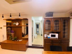 a living room with a kitchen and a microwave at Yama house in Tokyo
