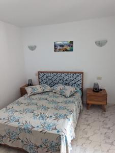 a bedroom with a bed and a nightstand next to it at NN Residence Tabarka in Tabarka