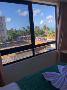 En eller flere senge i et værelse på Flat Mar C Branco - beira-mar