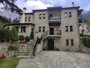 a large stone house with a stone driveway at Hotel Katafigio in Elati Trikalon