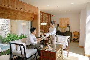 Villa ALANNA في شيانغ ماي: رجل وامرأة يقفان في غرفة المعيشة