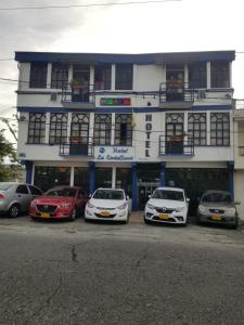 a group of cars parked in front of a building at Hotel La Castellana in Manizales