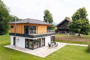 a large house with a deck and a patio at Im Mondseeland in Innerschwand am Mondsee