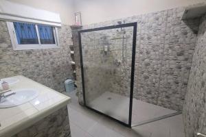 a bathroom with a shower and a sink at Villa Bonapriso avec piscine in Douala