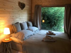 a bedroom with a bed with two teddy bears on it at Glamping U Lesní víly in Záchlumí