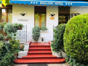 hotel z czerwonymi schodami prowadzącymi do drzwi wejściowych w obiekcie Hotel Bagliori w Mediolanie