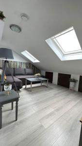 a living room with a skylight in the ceiling at Palaz 8 - One Bedroom Flat in Edmonton