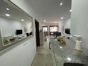 a kitchen and living room with a counter with fruit on it at Rosa Nautica 106 in La Herradura