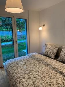 ein Schlafzimmer mit einem Bett und einem großen Fenster in der Unterkunft Luxusapartment an Traumlage in Lugano in Paradiso
