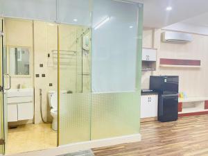 a bathroom with a glass shower with a toilet at Linh' house in Ho Chi Minh City