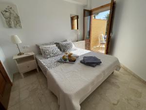 a bedroom with a bed with a tray of fruit on it at Rosa Nautica 106 in La Herradura