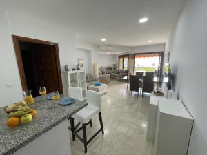a kitchen and living room with a table and chairs at Rosa Nautica 106 in La Herradura