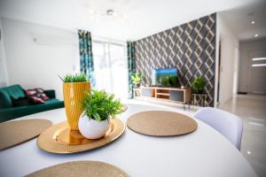 una mesa con dos plantas en una sala de estar en Wlodarska 4a Lux Premium, en Cracovia