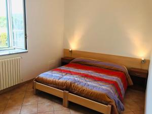 a bedroom with a bed and a window at Camia Etna House in Piedimonte Etneo