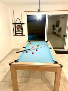 a pool table with balls on it in a room at Maison Piscine Spa près bordeaux in Ambarès-et-Lagrave