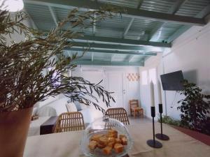 a room with a table with a bowl of food on it at Ammoudara's apartments Rooftop in Kalymnos