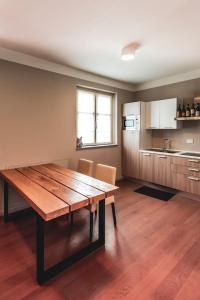 a kitchen with a wooden table in a room at Réva Resort in Monforte dʼAlba