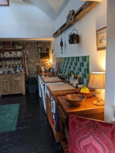 a large kitchen with wooden counters and a stove at Turrock Cottage in Shillelagh