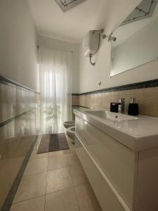 a white bathroom with a sink and a toilet at Gens Julia in Rome +35 photos