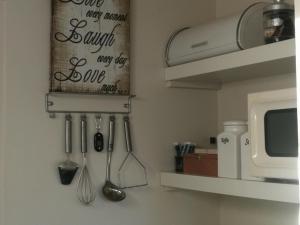 a kitchen with utensils hanging on a wall at Het Huisje in Bergen op Zoom
