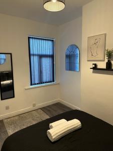 - une chambre avec un lit et 2 serviettes blanches dans l'établissement Short Stayzzz, à Manchester