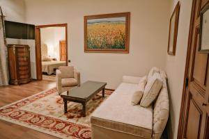 a living room with a couch and a table at Rigat Park & Spa Hotel - Adults Recommended in Lloret de Mar