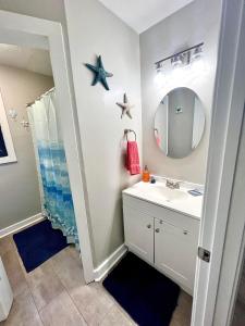 a bathroom with a sink and a mirror at 4/2 Home Close to Beach, Centrally located! in Gulfport