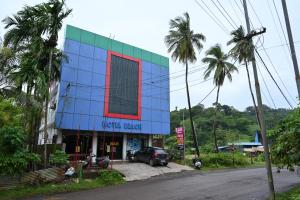 a hotel building with a car parked in front of it at HOTEL BEACH A/C in Port Blair