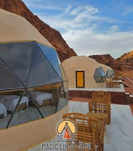 two domed tents with chairs and tables in the desert at wadi rum,Linda Camp in Wadi Rum