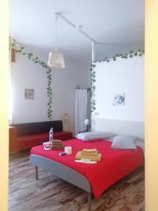 a bedroom with a red bed with a red blanket at ITALIAN Bed Breakfast in Paglieta