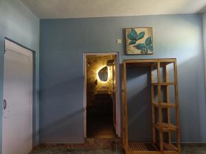 a hallway with a blue wall and a stair case at The Bunksters Bir in Bīr