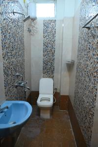 a bathroom with a toilet and a sink at HOTEL BEACH A/C in Port Blair