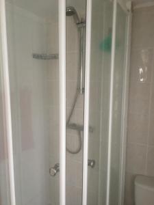 a bathroom with a shower with a glass door at Tamaras Place in Leysdown-on-Sea