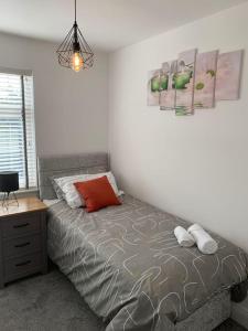 a bedroom with a bed and a nightstand and a bed sidx sidx sidx sidx at NEC/Airport - The Allium, Two bedroom apartment in Marston Green