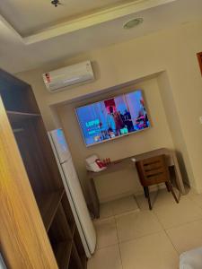a room with a flat screen tv on the wall at Studio Comfort Flamengo in Rio de Janeiro