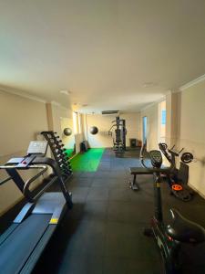 a gym with treadmills and exercise bikes in a room at Studio Comfort Flamengo in Rio de Janeiro
