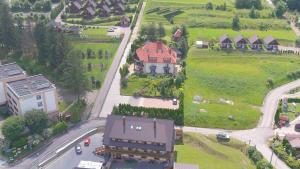 an aerial view of a house with a road and houses at Noclegi Solina Sunrise in Solina
