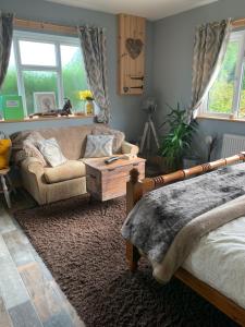 a living room with a bed and a couch at Wild winds Annex in New Quay