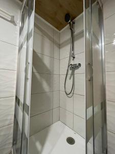 a shower with a glass door in a bathroom at Abrigo do Outeiro - Serra Da Estrela in Cabeça