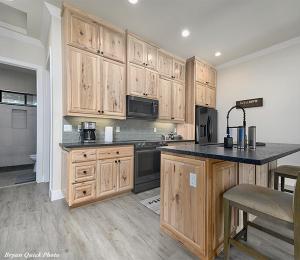 a kitchen with wooden cabinets and a counter top at Three Bedroom River Access in Redding