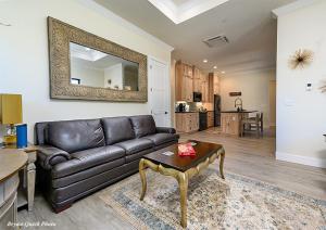 a living room with a leather couch and a mirror at Three Bedroom River Access in Redding