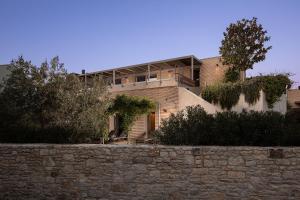 a building with a stone wall in front of it at Casa Arbor Blanco with a see view and heated infinity pool in Fažana