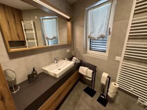 a bathroom with a sink and a mirror at Apartment Deluxe Ossiacher See - Gerlitzen in Sattendorf