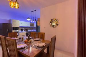 SeaSand-Entire Luxury 3 BD condo - Close to beach في فليك-إن-فلاك: غرفة طعام مع طاولة ومطبخ