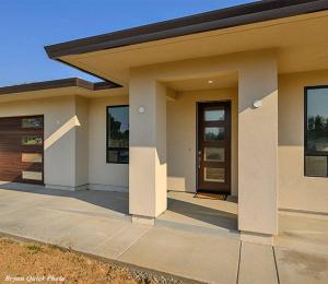 a small house with a door and a sidewalk at Two bedroom with river access in Redding