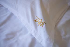 a white shirt with a gold insignia on it at Pensiunea Diva in Cacica