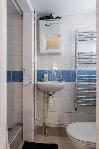 a bathroom with a sink and a toilet at Quality Stay Room in Brighton & Hove