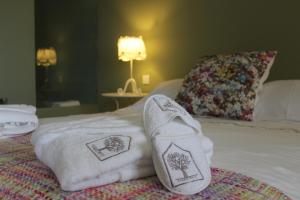 a pair of socks and towels on a bed at Casas da Li in Arcos de Valdevez +127 photos